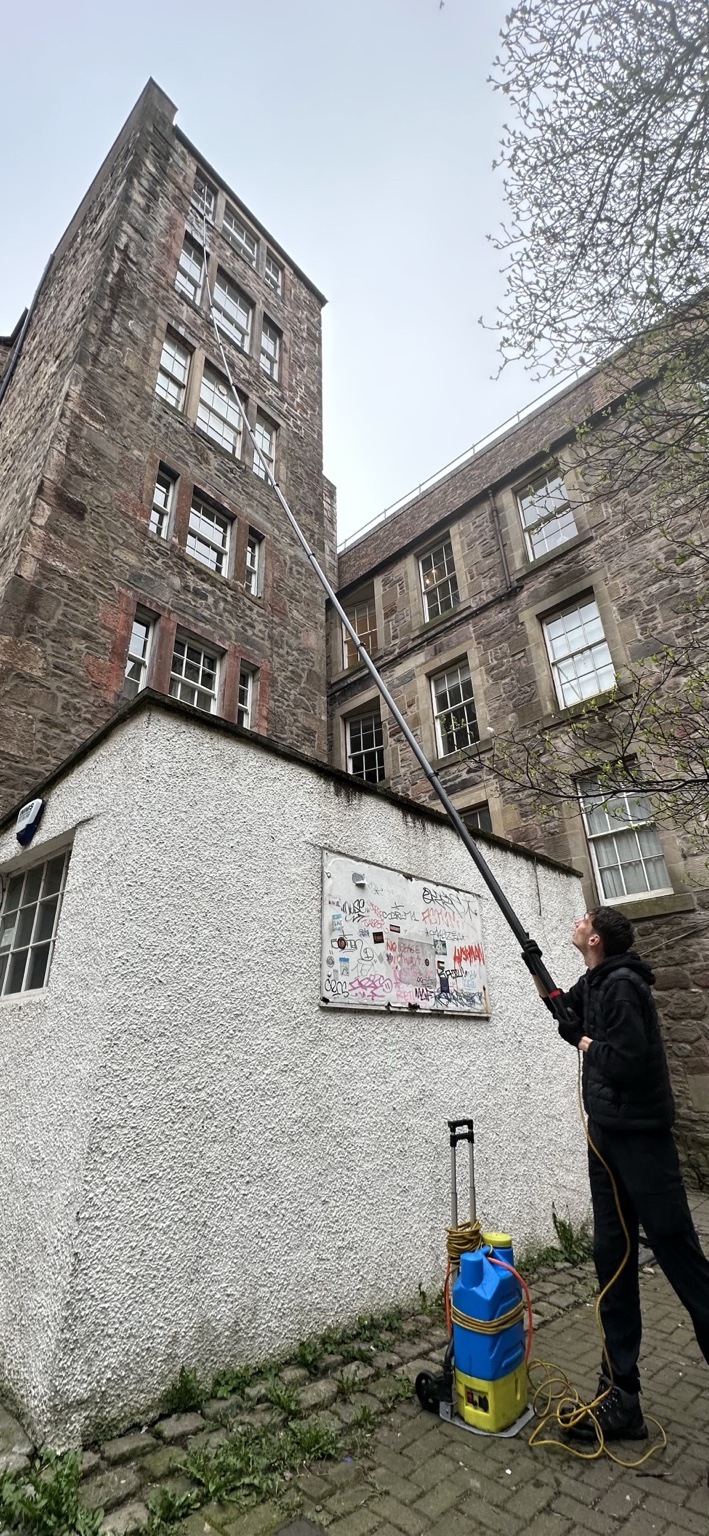 Window cleaner using reach and wash pole in Edinburgh